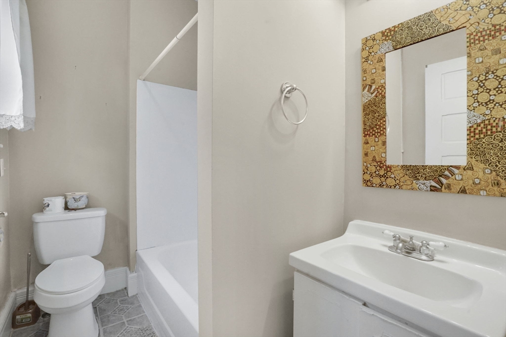 55 Florida Street Springfield, MA 01109 - Photo 19 of 42 a bathroom with a toilet sink and mirror