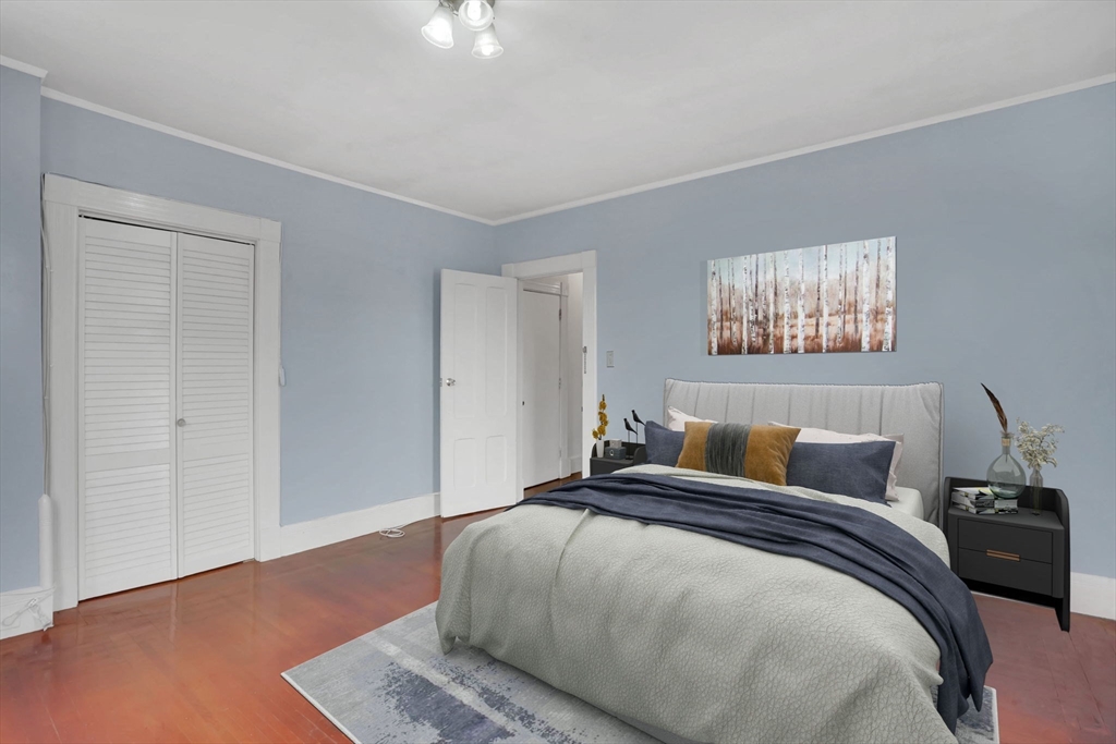 55 Florida Street Springfield, MA 01109 - Photo 22 of 42 a bedroom with a bed and a night stand