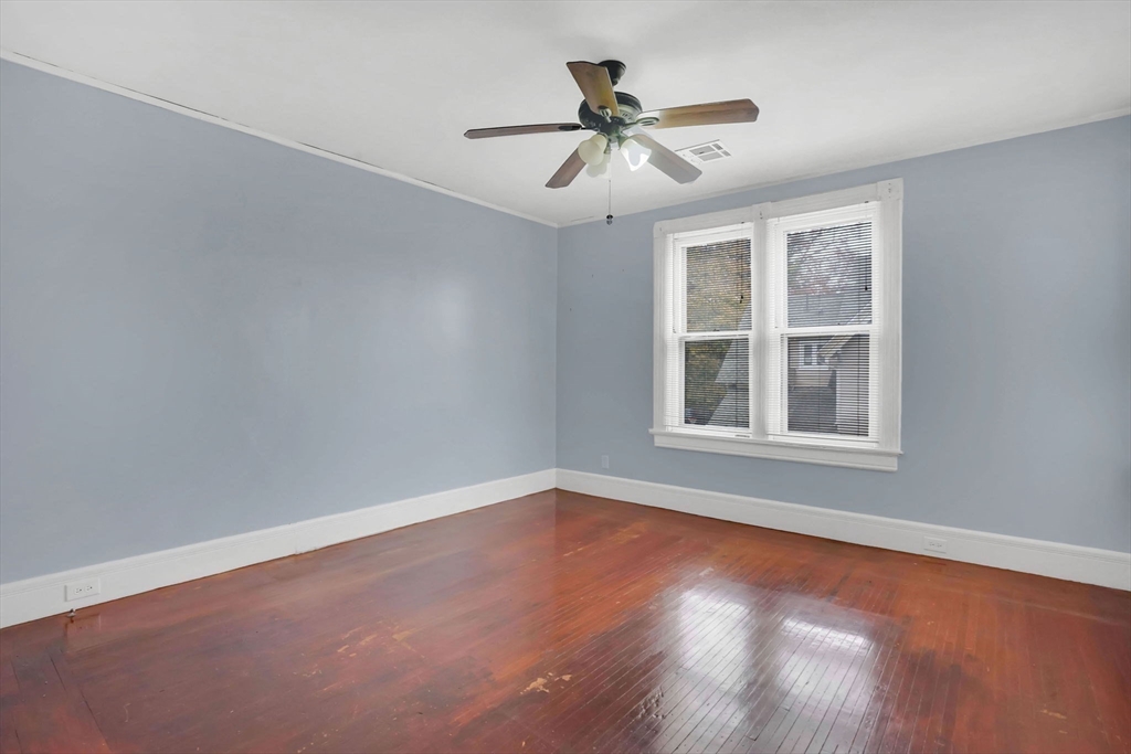55 Florida Street Springfield, MA 01109 - Photo 23 of 42 a view of an empty room with wooden floor and a window