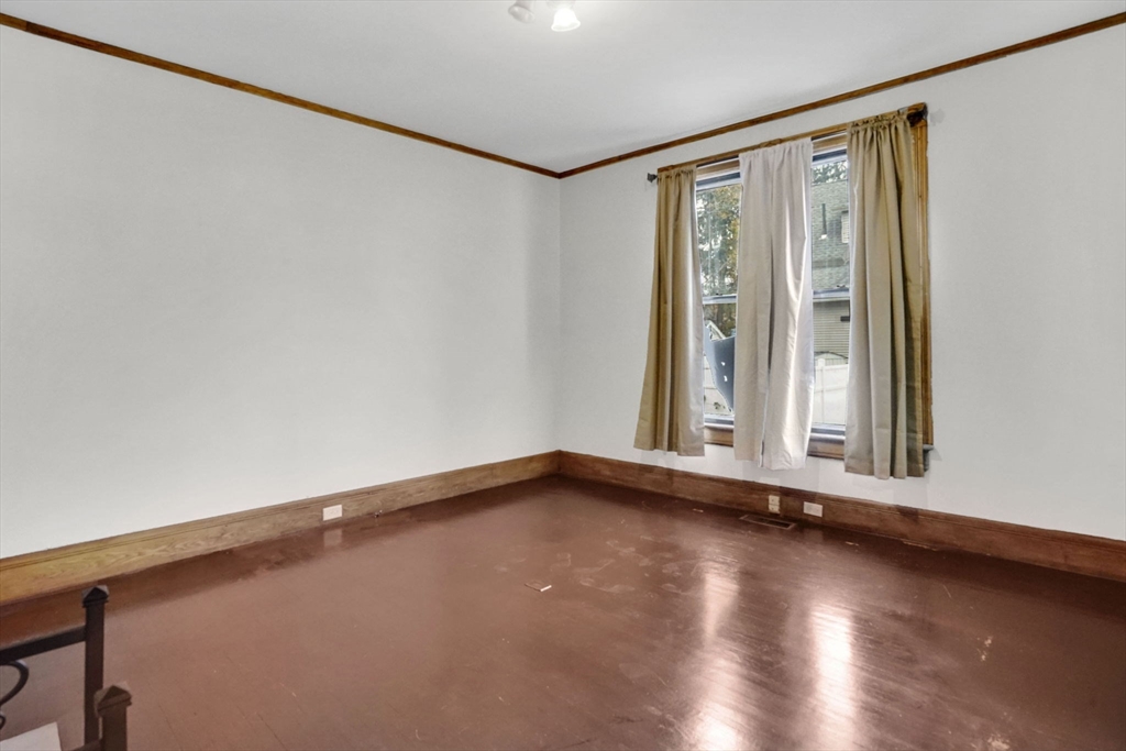 55 Florida Street Springfield, MA 01109 - Photo 5 of 42 a view of a room with wooden floor and window