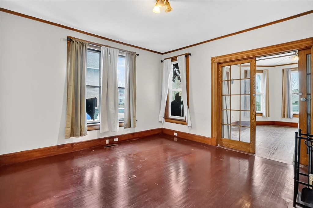 55 Florida Street Springfield, MA 01109 - Photo 6 of 42 a view of an empty room with glass door and wooden floor