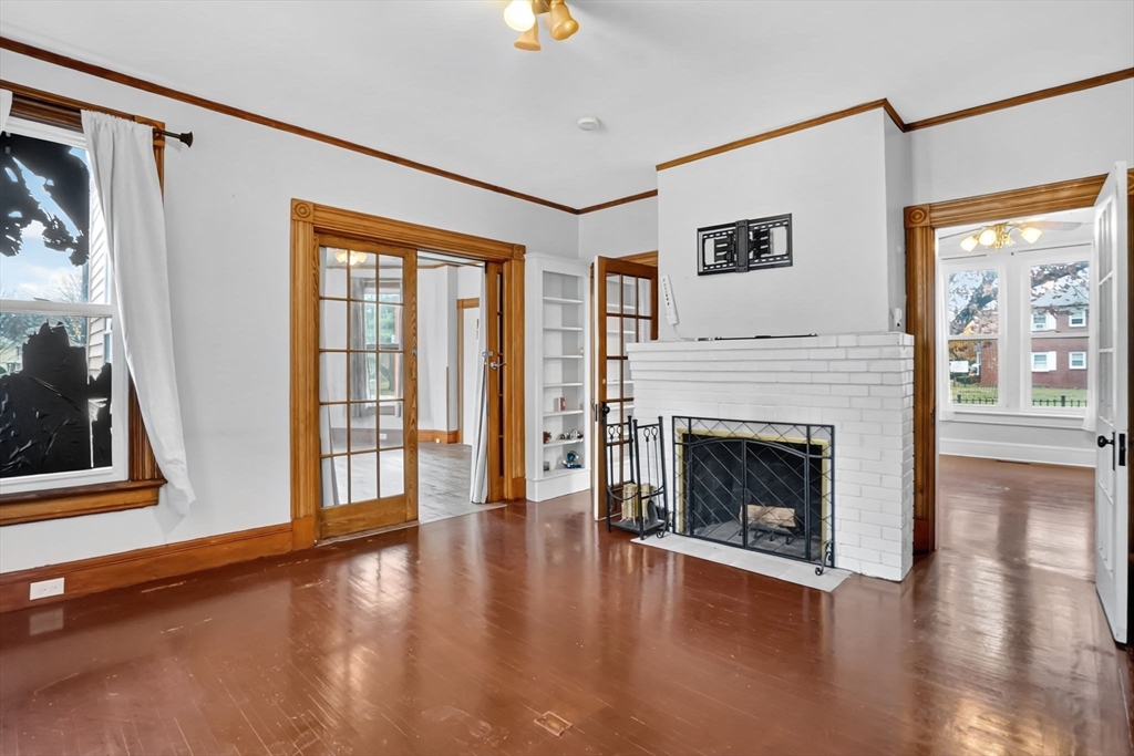 55 Florida Street Springfield, MA 01109 - Photo 9 of 42 a living room with wooden floor and a fireplace