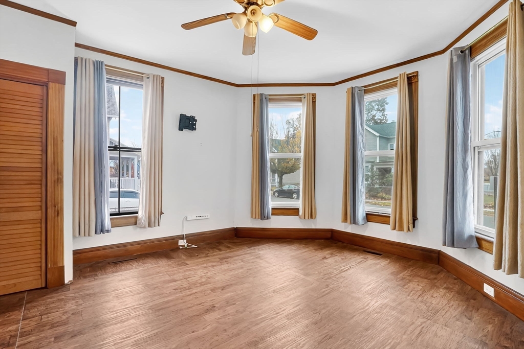 55 Florida Street Springfield, MA 01109 - Photo 10 of 42 an empty room with wooden floor and windows