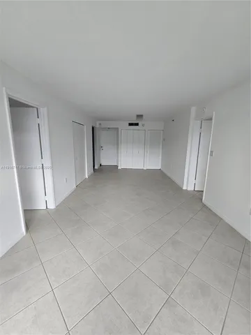 a view of an empty room and entryway