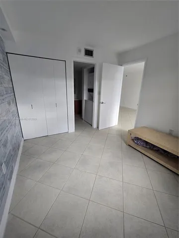 a view of a livingroom with an empty space and a sink window
