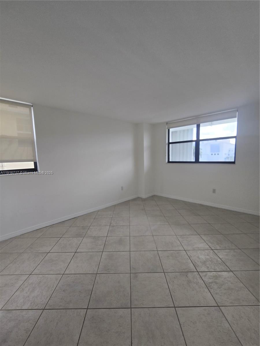 1775 Washington Avenue, Unit 4G Miami Beach, FL 33139 - Photo 18 of 44 an empty room with windows