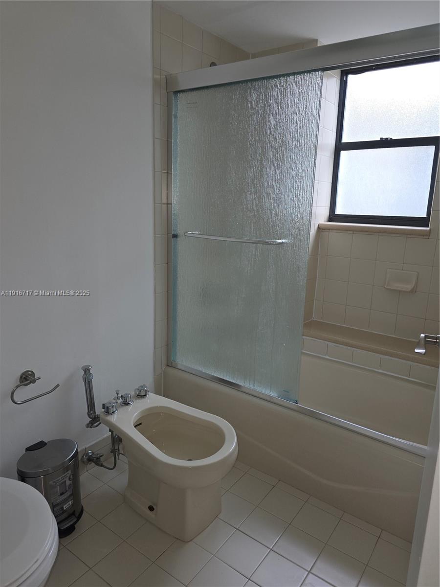 1775 Washington Avenue, Unit 4G Miami Beach, FL 33139 - Photo 19 of 44 a white toilet sitting next to a bathroom sink