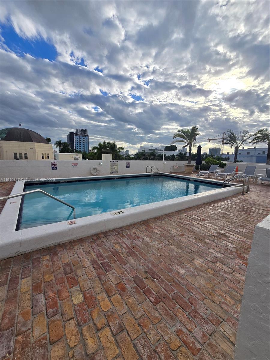 1775 Washington Avenue, Unit 4G Miami Beach, FL 33139 - Photo 23 of 44 a view of a swimming pool with an outdoor seating