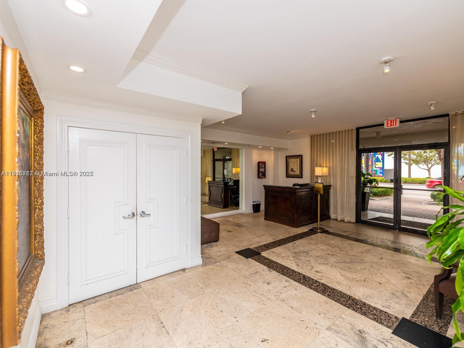 1775 Washington Avenue, Unit 4G Miami Beach, FL 33139 - Photo 25 of 44 a living room with furniture and a flat screen tv