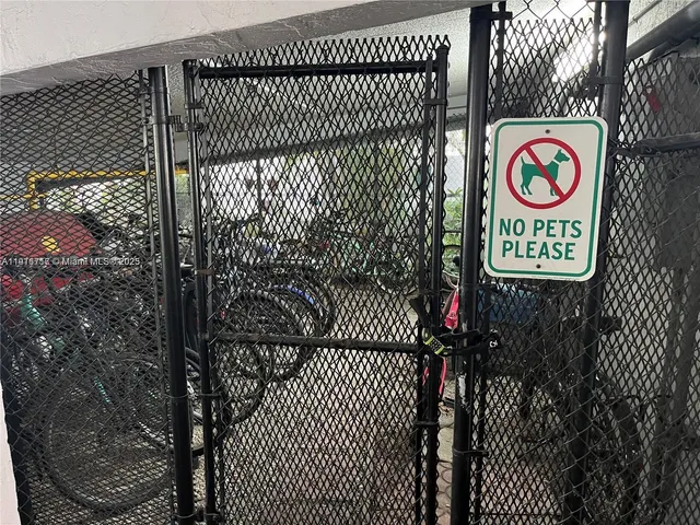 a street sign on a wall next to a gate