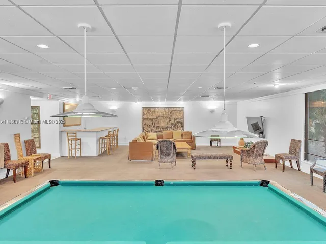 a living room with lots of furniture and a chandelier