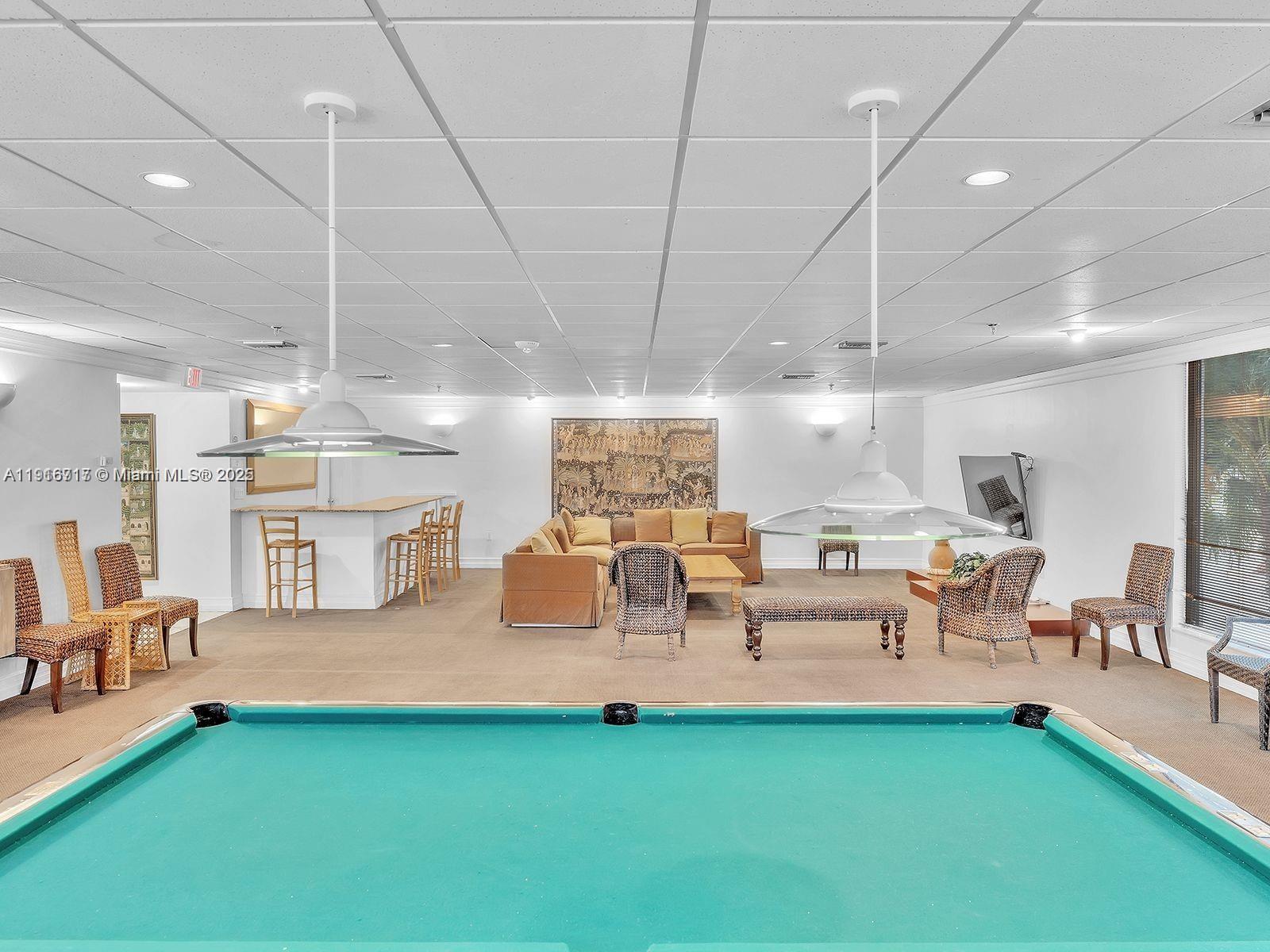 1775 Washington Avenue, Unit 4G Miami Beach, FL 33139 - Photo 28 of 44 a living room with lots of furniture and a chandelier