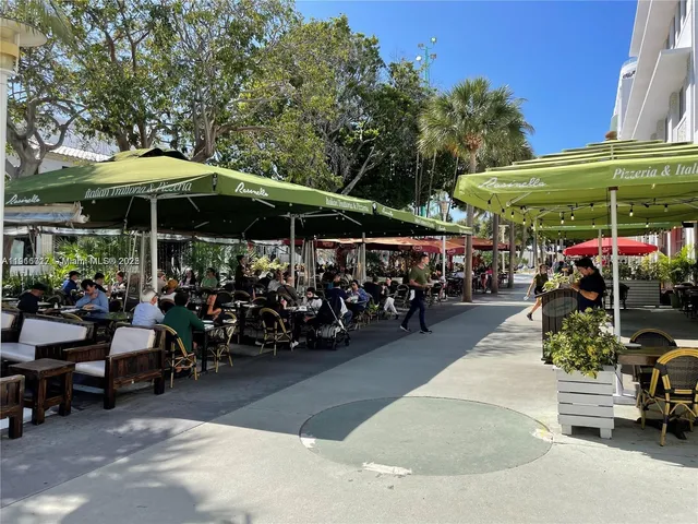 a view of a chairs and tables in patio and a umbrella