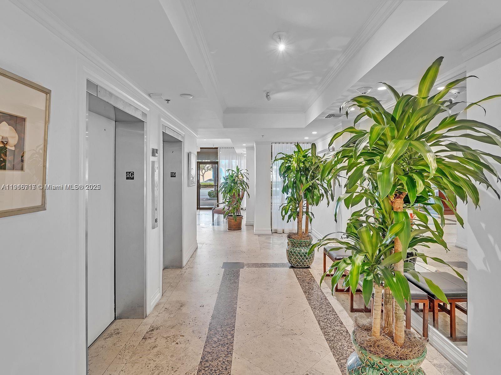 1775 Washington Avenue, Unit 4G Miami Beach, FL 33139 - Photo 7 of 44 a hallway with with a plant in it