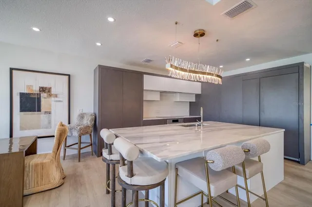 a kitchen with a sink a counter top space and stainless steel appliances