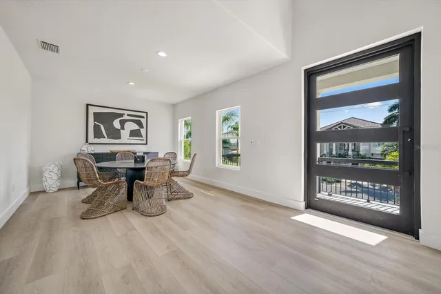 a view of a work space with wooden floor and a window