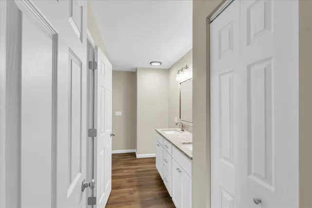 a bathroom with a double vanity sink and mirror