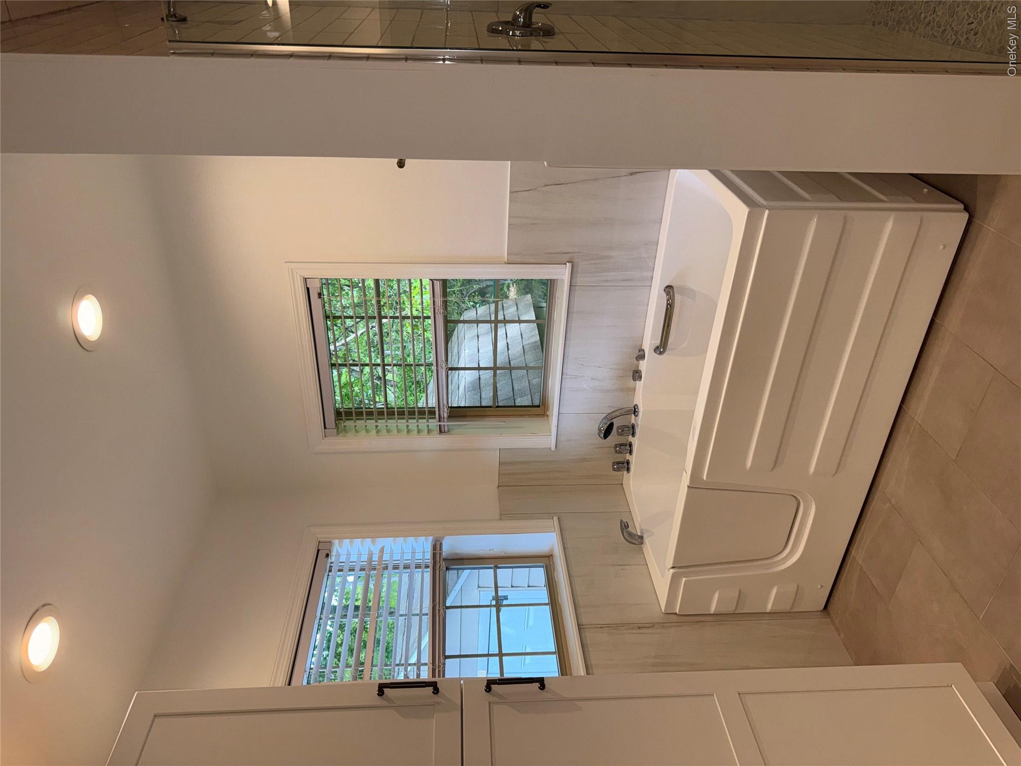 1661 Old Country Road, Unit 516 Riverhead, NY 11901 - Photo 41 of 50 a spacious bathroom with sink and mirror