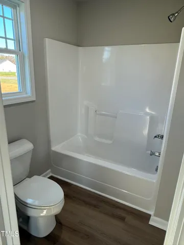 a bathroom with a toilet and a bathtub