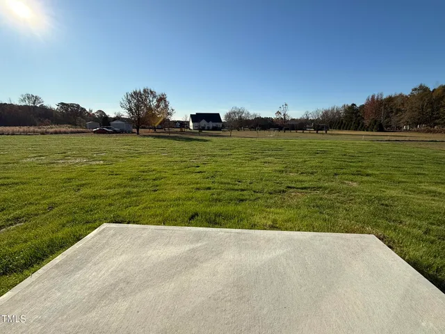 a view of a field with an ocean view