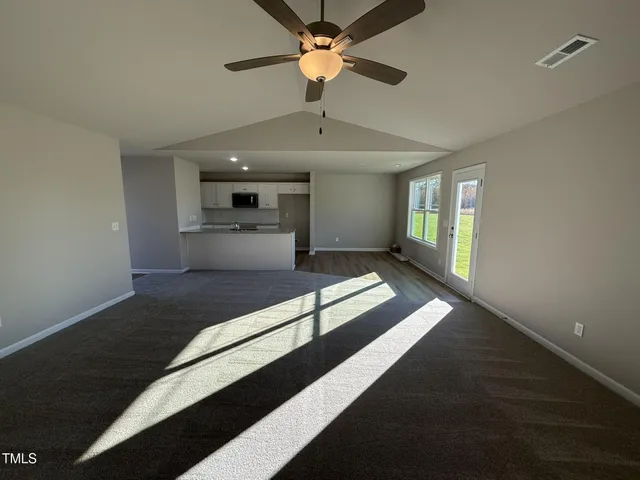 a spacious bedroom with a bed and a chandelier