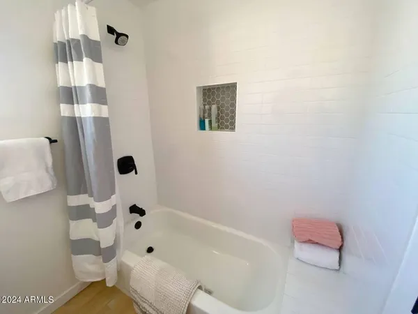 a bathroom with a bathtub and shower