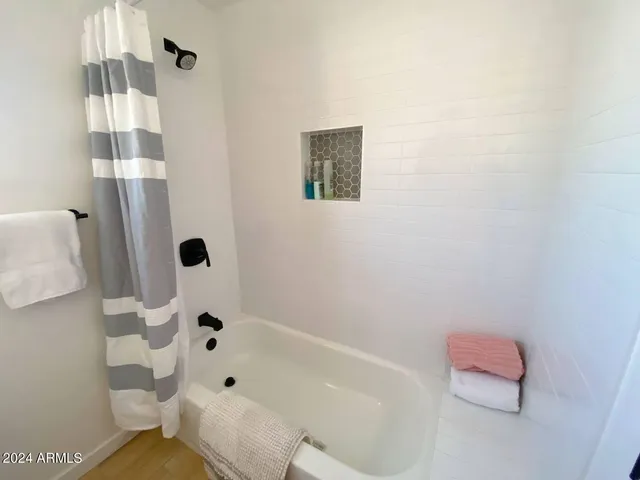 a bathroom with a bathtub and shower