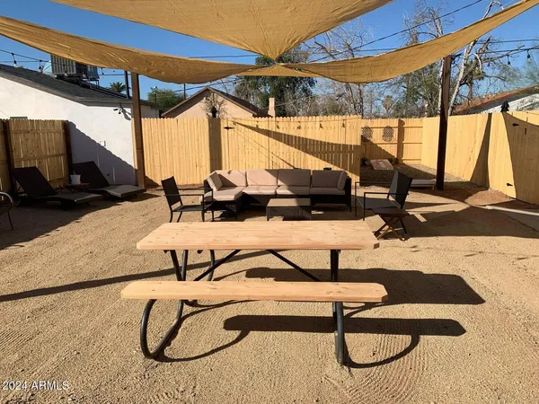 a view of swimming pool with a patio and a backyard
