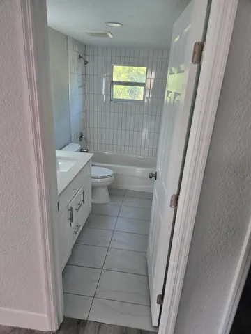 a bathroom with a double vanity sink toilet and shower