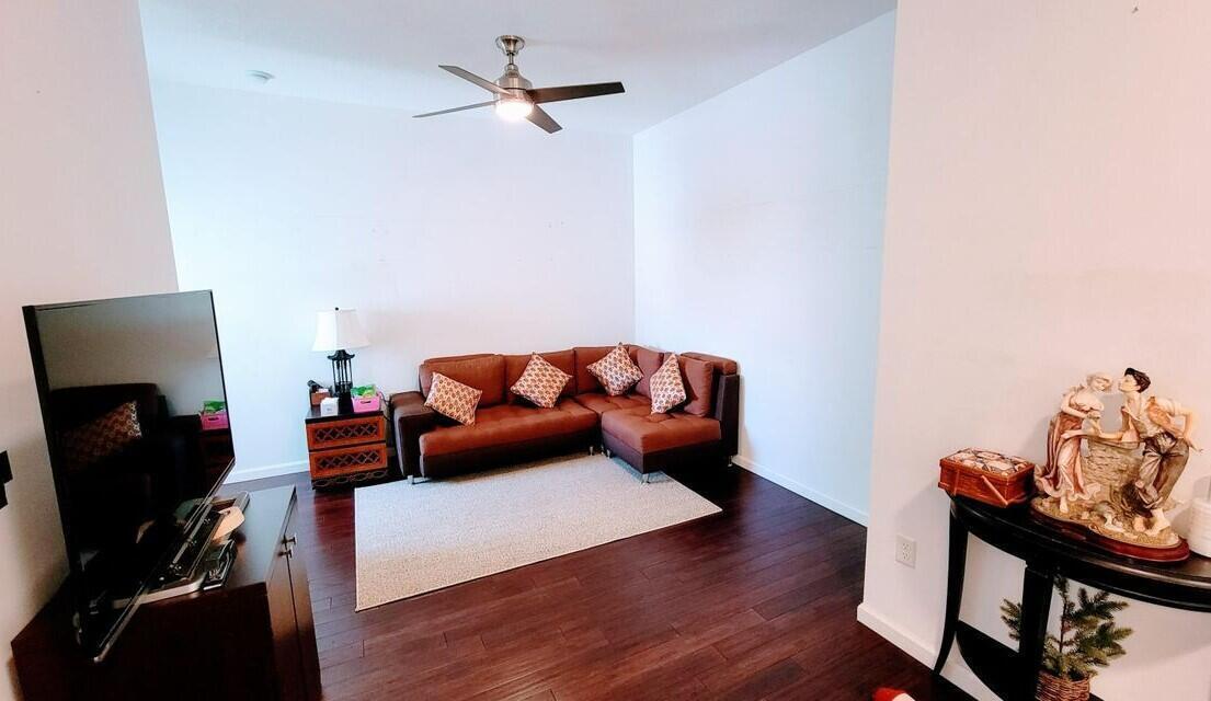 4858 Northwest 16th Terrace Boca Raton, FL 33431 - Photo 11 of 38 a living room with furniture and a flat screen tv