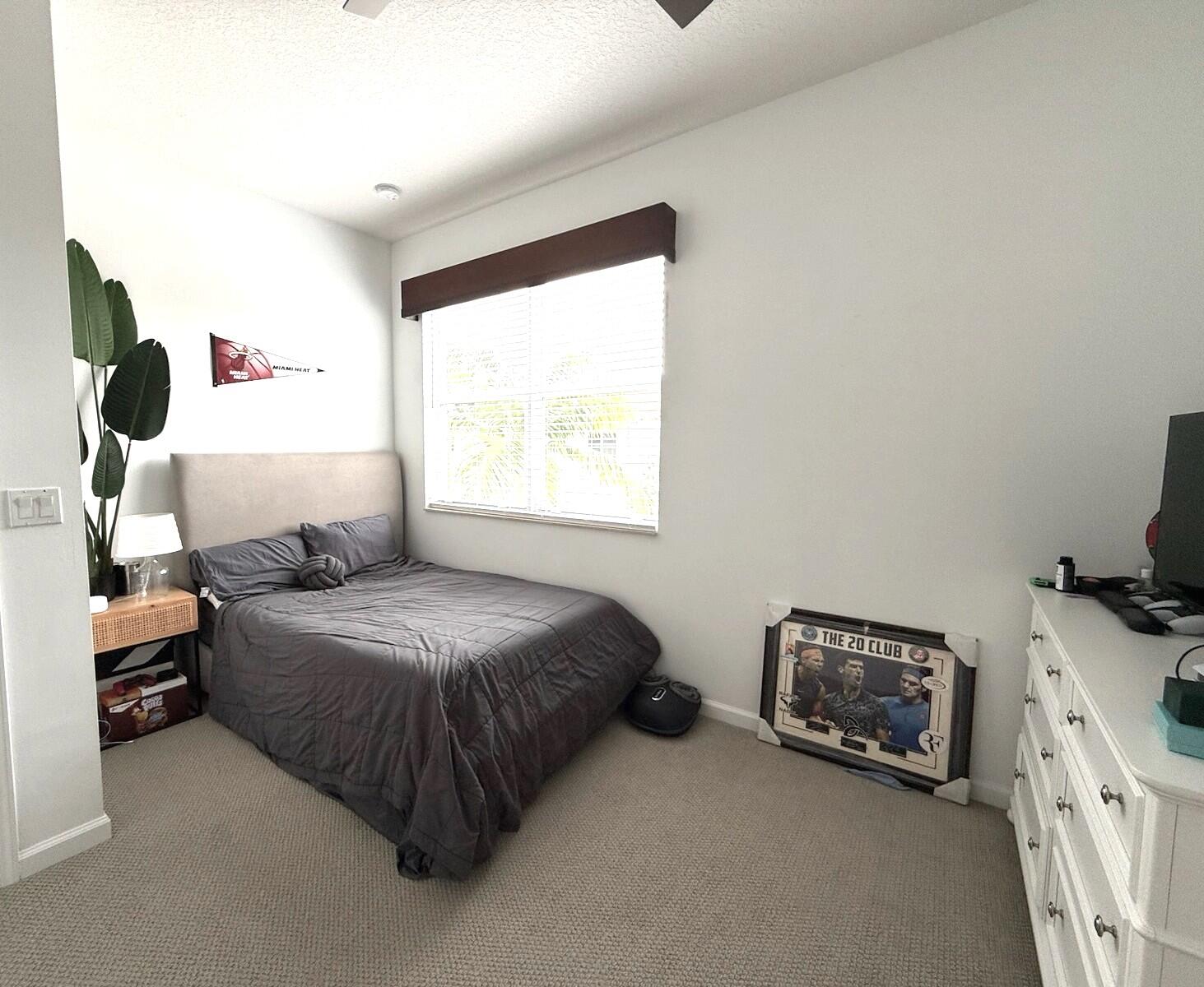 4858 Northwest 16th Terrace Boca Raton, FL 33431 - Photo 18 of 38 a bedroom with a bed and a window