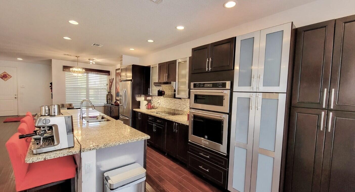 4858 Northwest 16th Terrace Boca Raton, FL 33431 - Photo 7 of 38 a kitchen with a refrigerator stove and sink