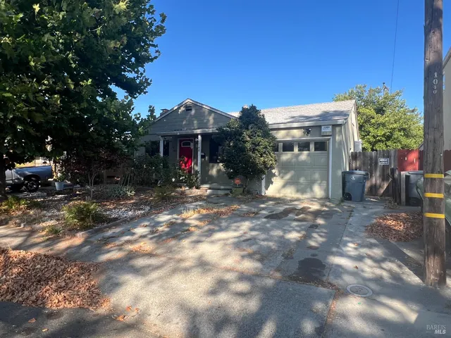 a view of the house with backyard and sitting area