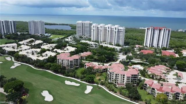 an aerial view of lake and residential houses with outdoor space