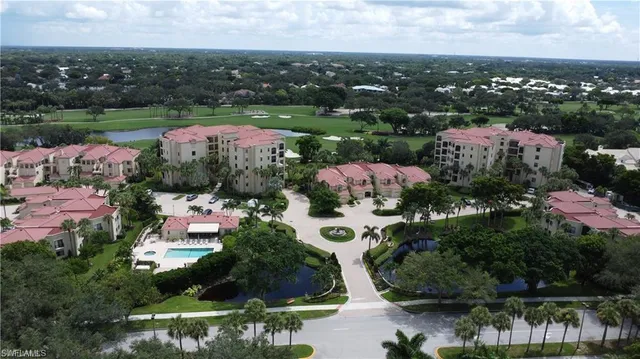 an aerial view of a house with garden space and lake view in back
