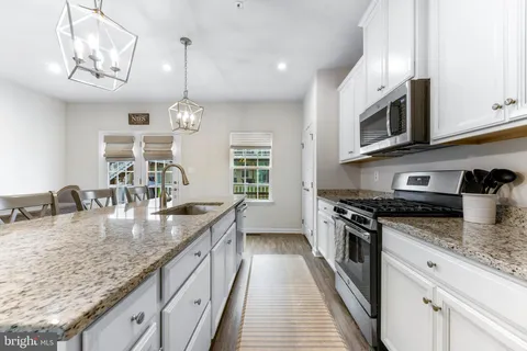 a kitchen with stainless steel appliances granite countertop a lot of counter space