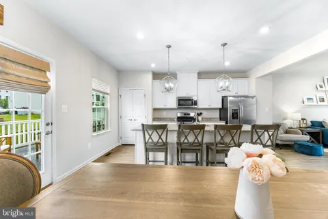 a living room with lots of furniture and kitchen view