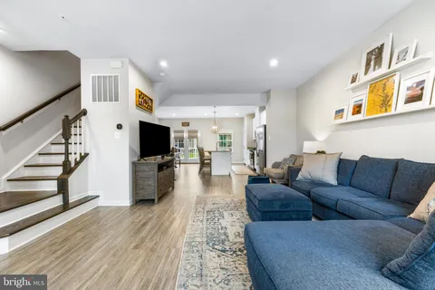 a living room with furniture flat screen tv and a fireplace
