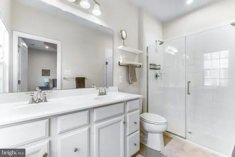a bathroom with a sink double vanity and a shower
