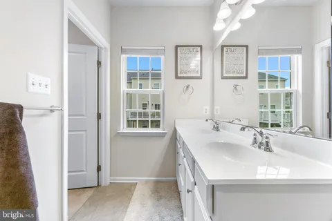 a view of walk in closet with clothes