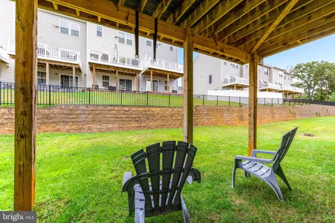 a view of an house with backyard porch and sitting area