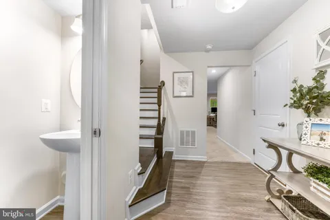a view of an entryway with wooden floor