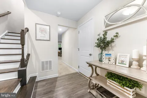 a view of an entryway with wooden floor and a front door