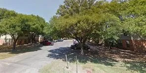 a view of a tree in a yard