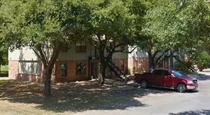 a view of a tree in the backyard of a house