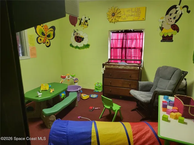 a bedroom with a bed a couch and a painting on the wall