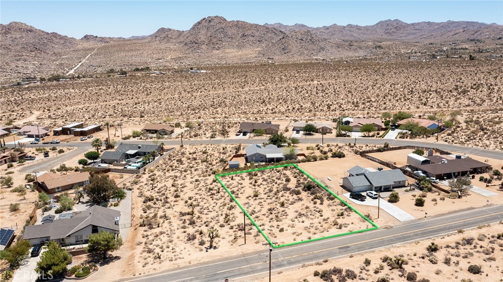 an aerial view of residential house and sandy dunes