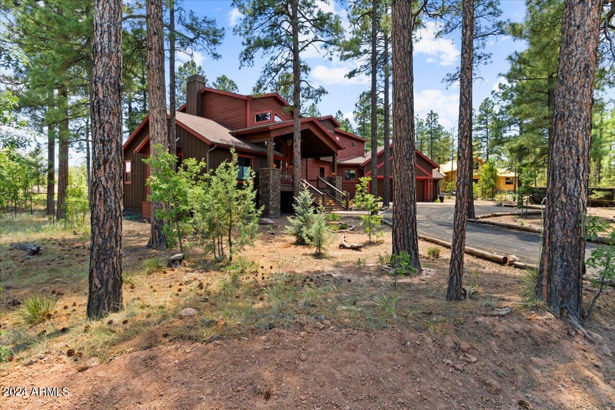4051 West Falling Leaf Road Show Low, AZ 85901 - Photo 15 of 77 a view of a chairs and fire pit in the middle of a yard