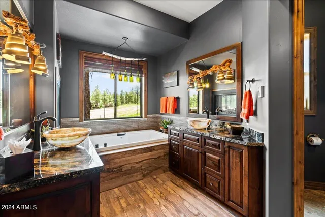 a view of a deck with table and chairs under an umbrella with wooden floor