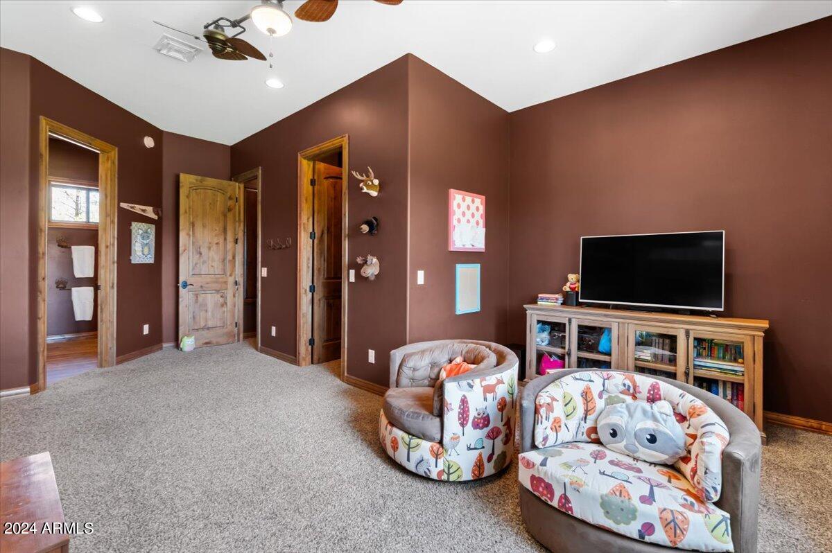 4051 West Falling Leaf Road Show Low, AZ 85901 - Photo 53 of 77 a bedroom with furniture and a flat screen tv